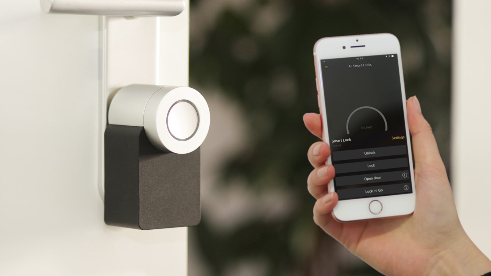 A small voice-controlled smart speaker sitting on a table in a softly lit living room.