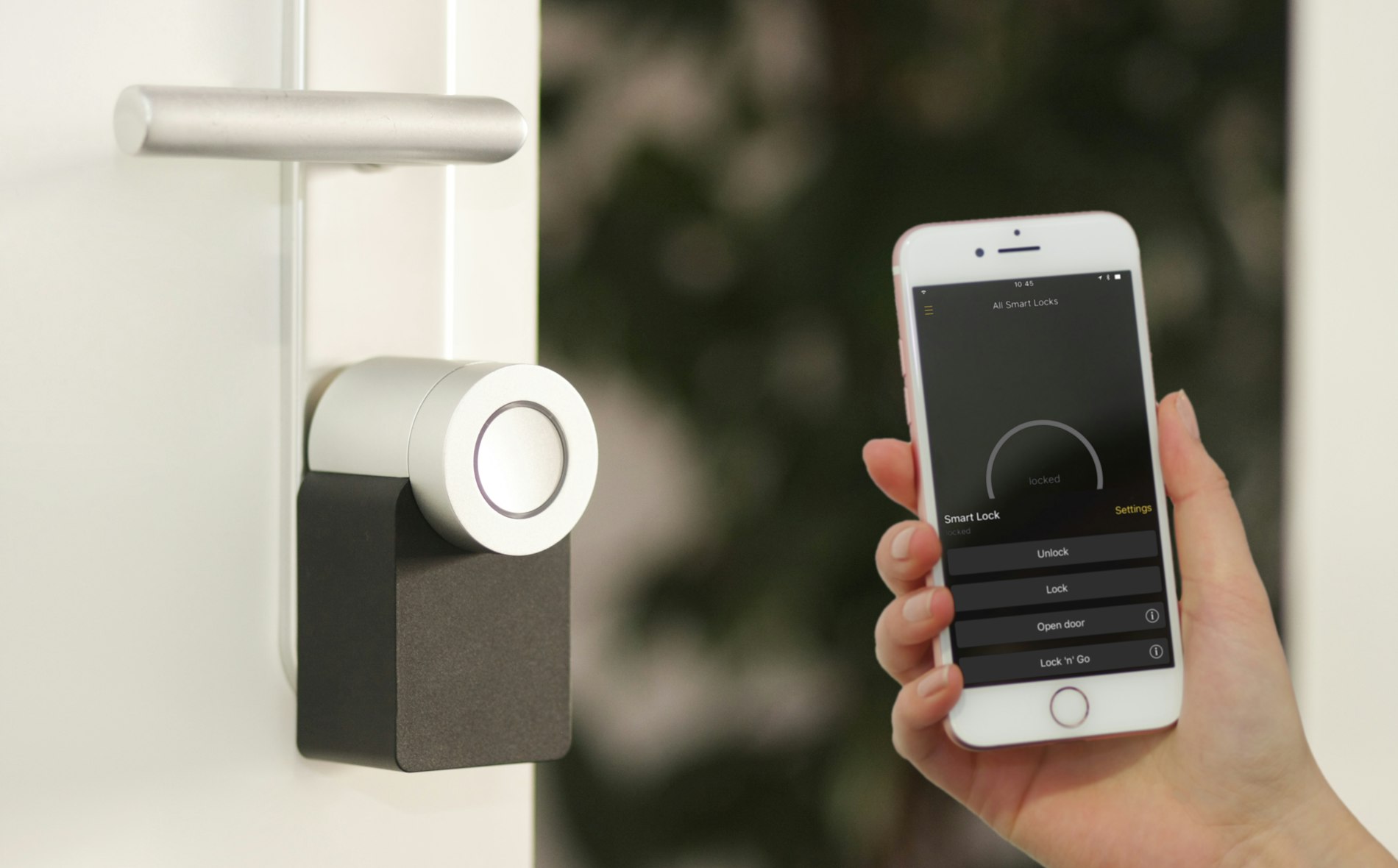 A small voice-controlled smart speaker sitting on a table in a softly lit living room.