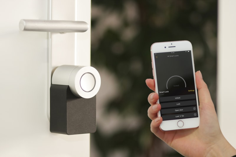 A small voice-controlled smart speaker sitting on a table in a softly lit living room.