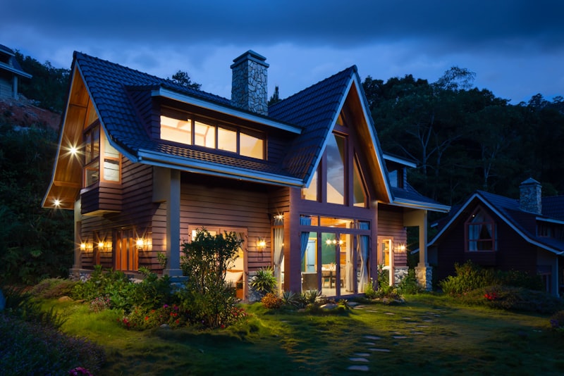A modern house with large windows seen at dusk.