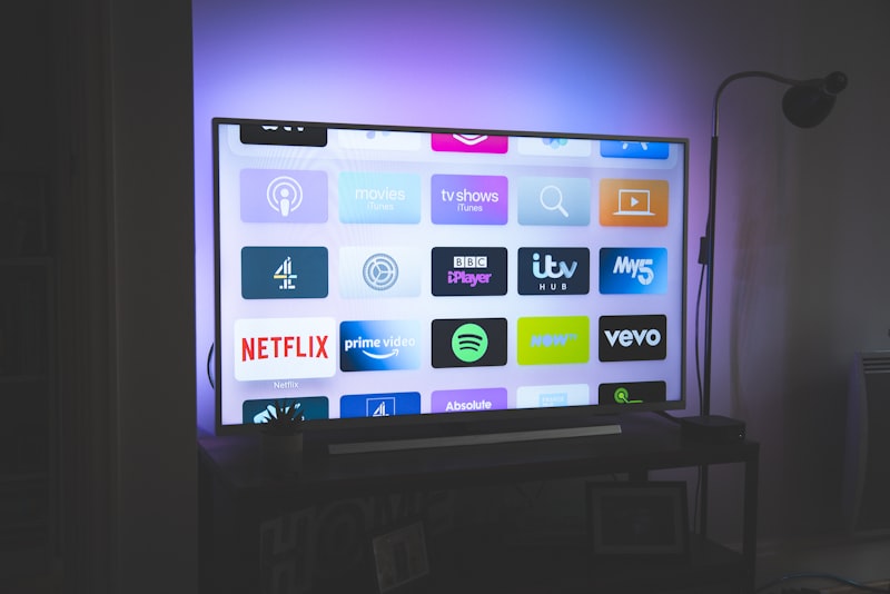 A smart speaker and hub on a shelf at home.